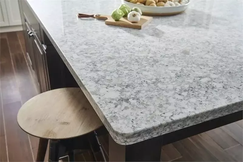 White granite kitchen island countertop and wooden stool